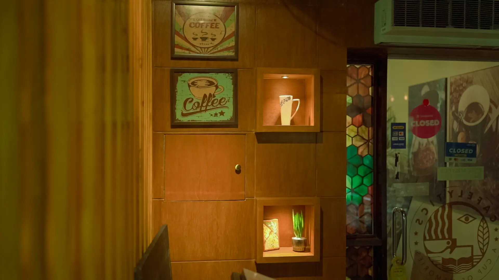 Warm wood-panelled entrance and display wall inside Cafelytics