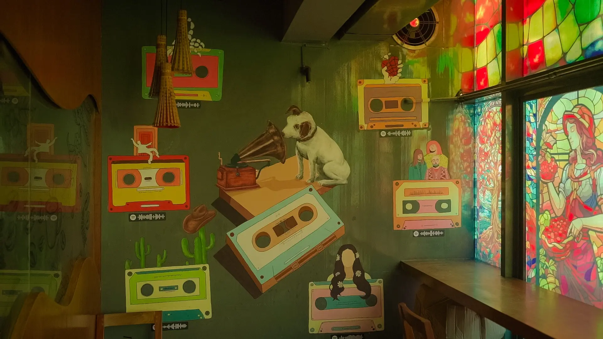 Music-themed mural and colourful window artwork inside Cafelytics