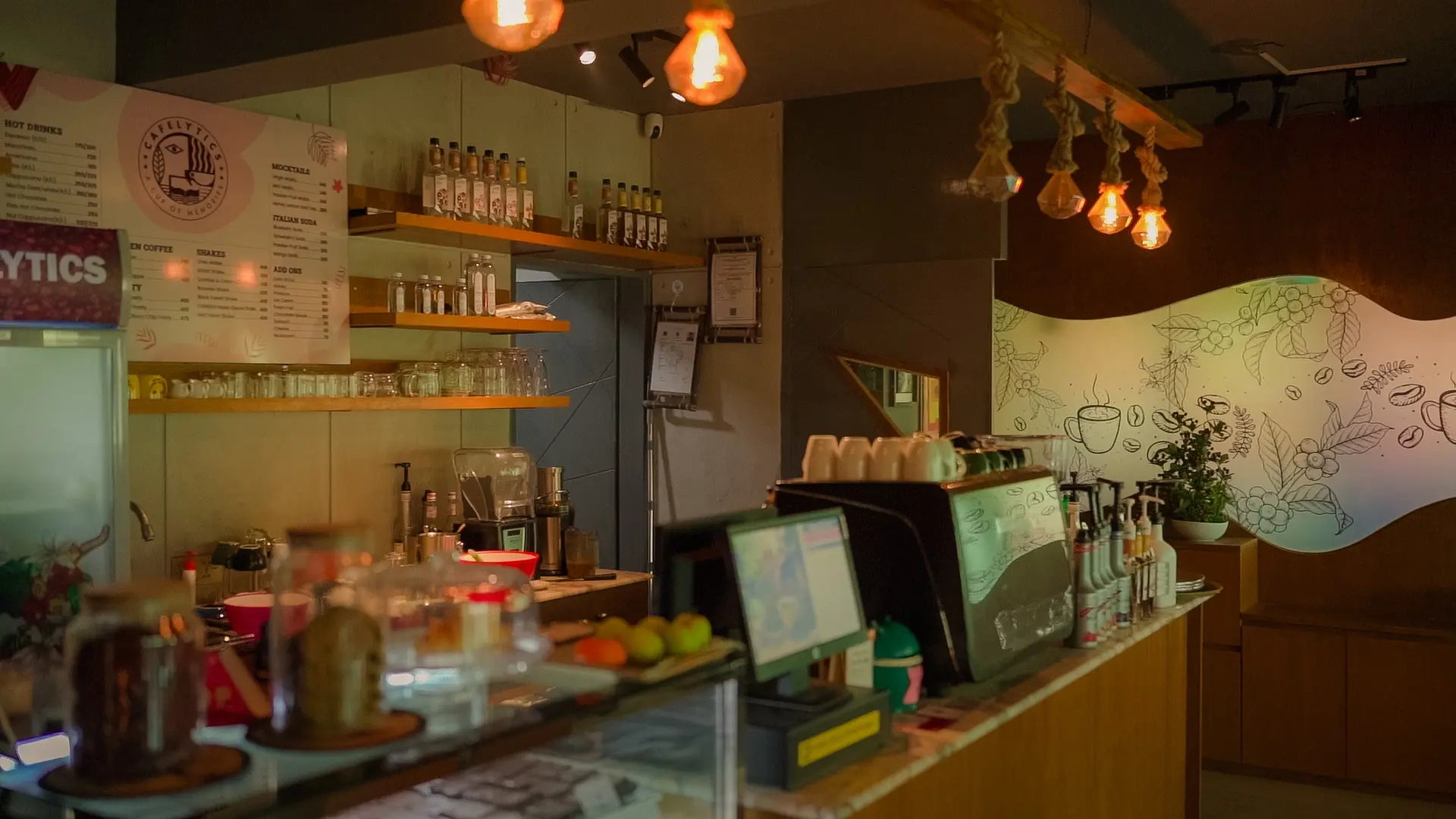 Cafelytics coffee counter beneath warm pendant lights