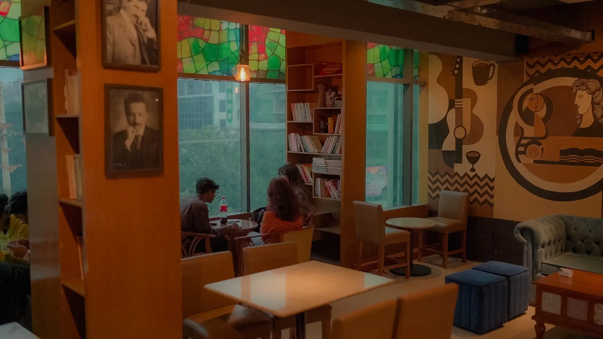 Cafelytics dining room with window seating, books and wall art